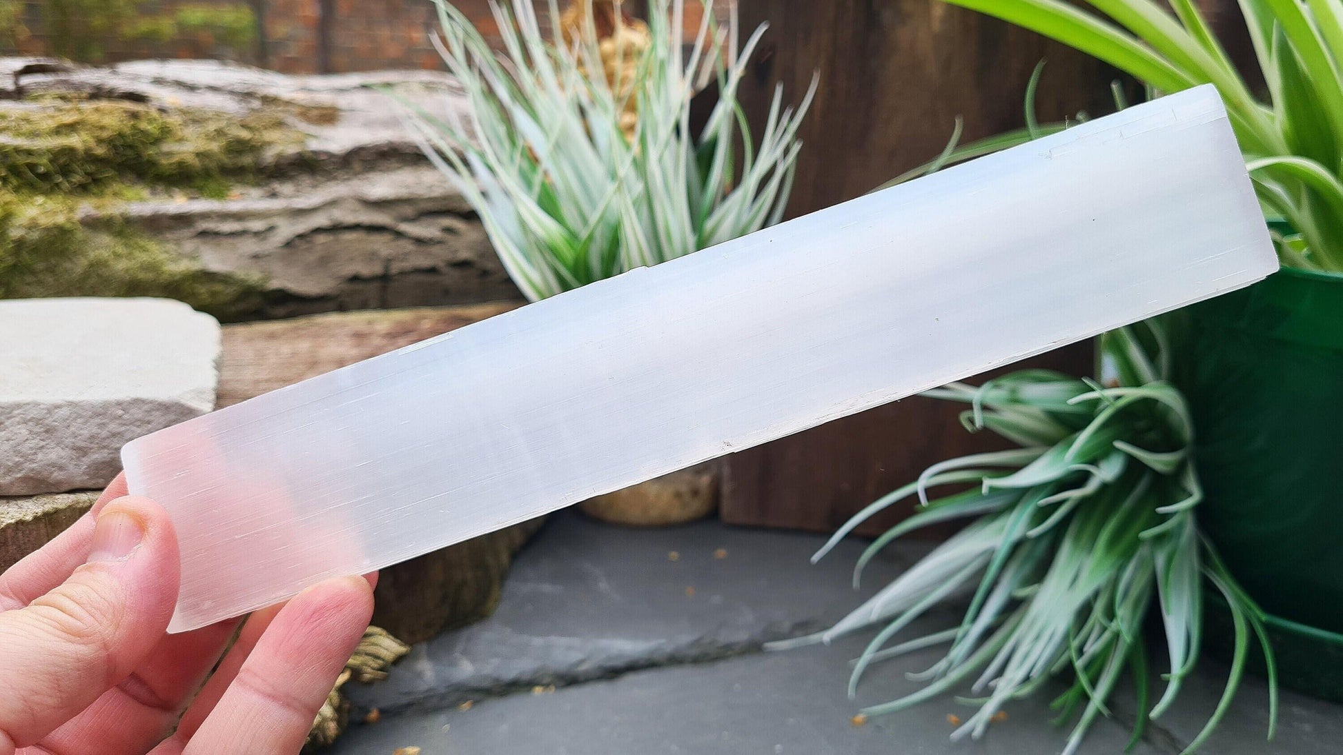 Selenite, a natural slab for cleansing and charging crystals. Use at the crown chakra to bring clarity and peace, aiding meditation and spiritual expansion.