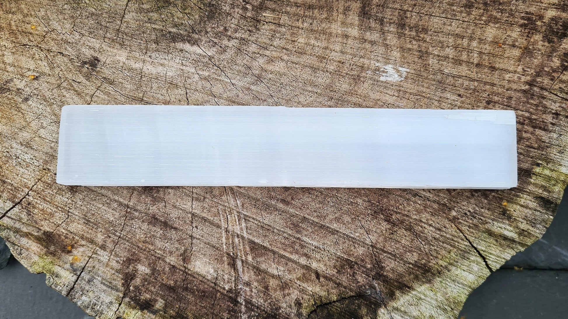 Selenite, a natural slab for cleansing and charging crystals. Use at the crown chakra to bring clarity and peace, aiding meditation and spiritual expansion.
