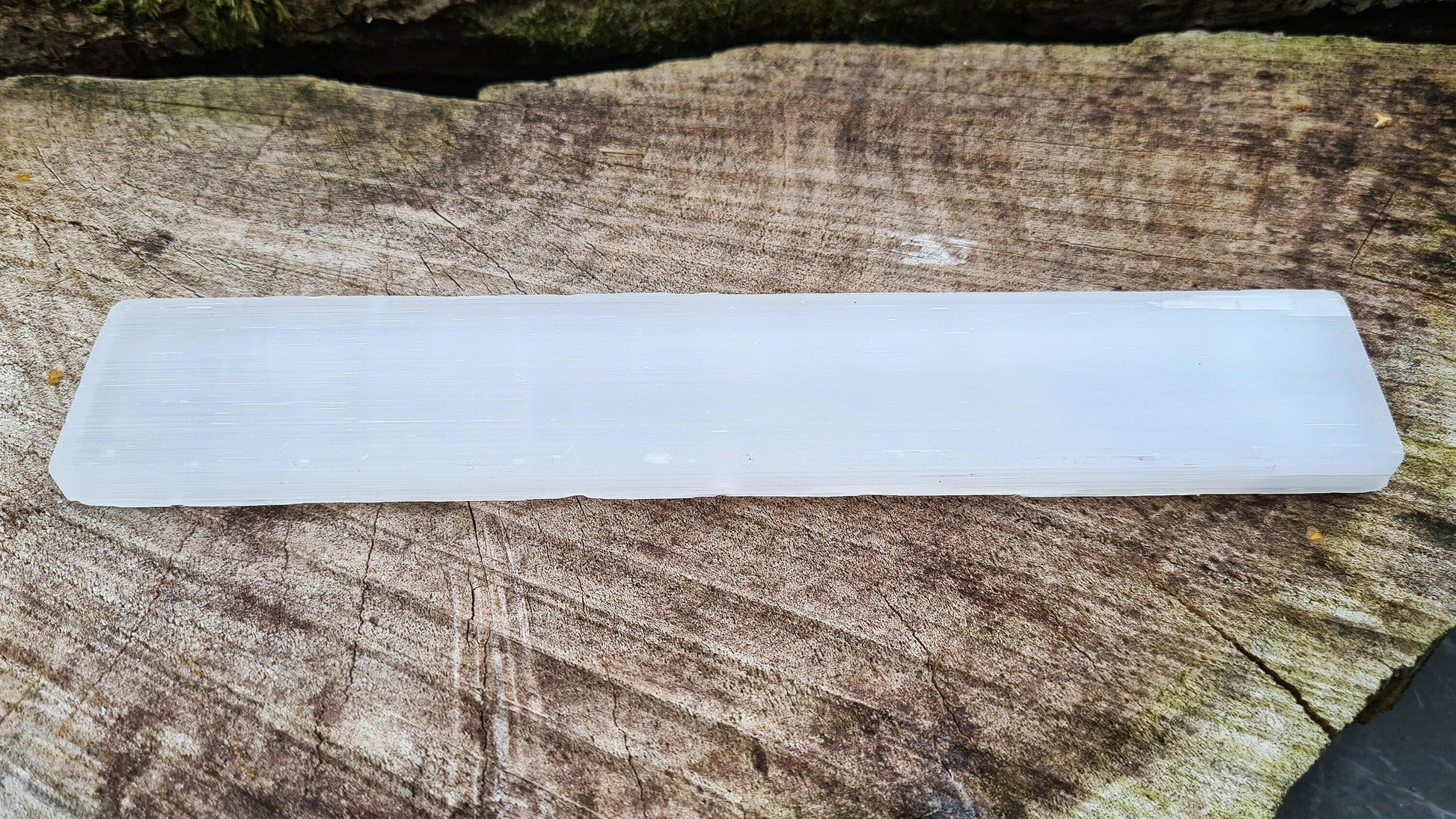 Selenite, a natural slab for cleansing and charging crystals. Use at the crown chakra to bring clarity and peace, aiding meditation and spiritual expansion.