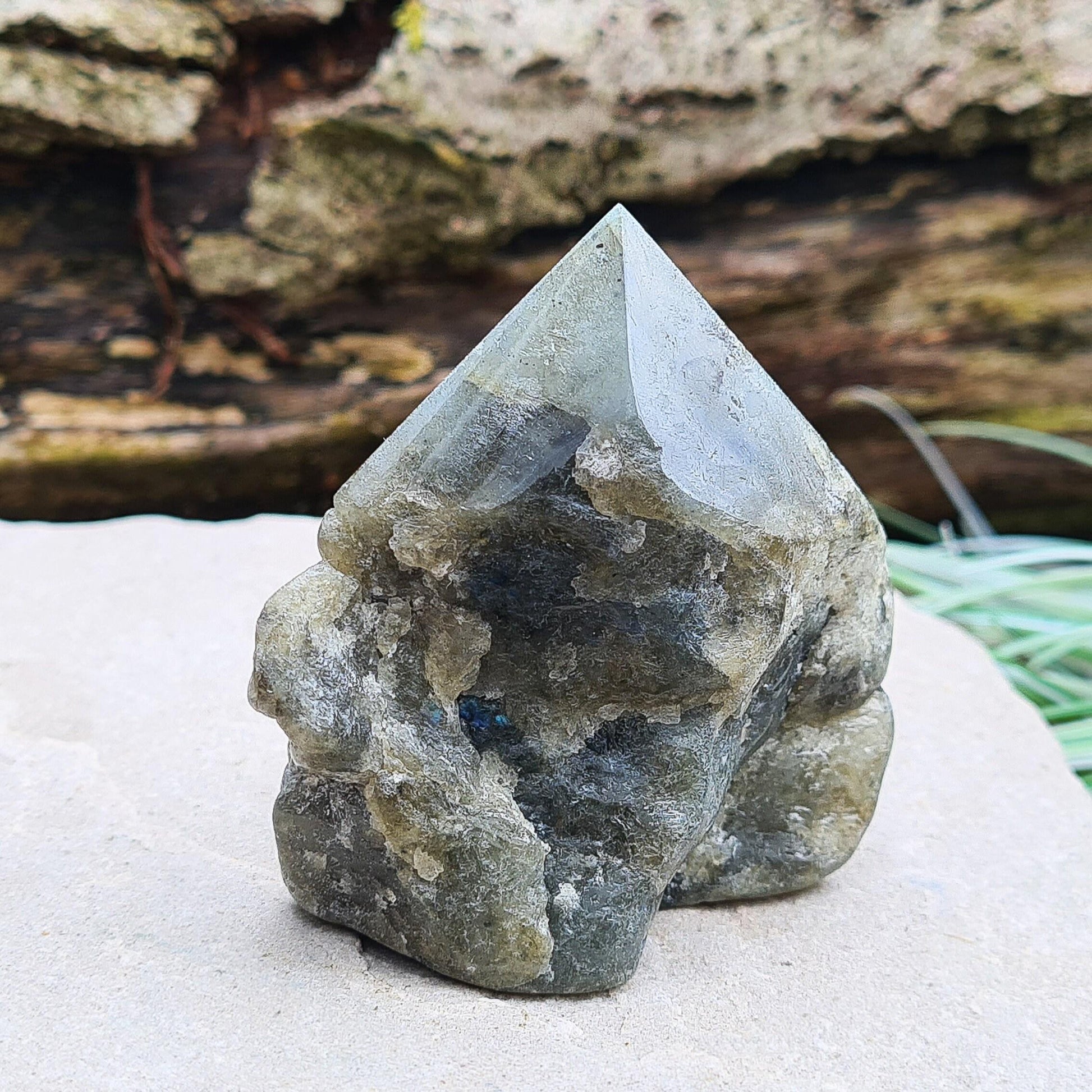 Labradorite Crystal, Standing Point, also known as Spectrolite. Tip has been polished, base has been polished and the natural sides feel like they have been smoothed out also. Piece has some blue flash which can be seen in the right light and at the right angle.