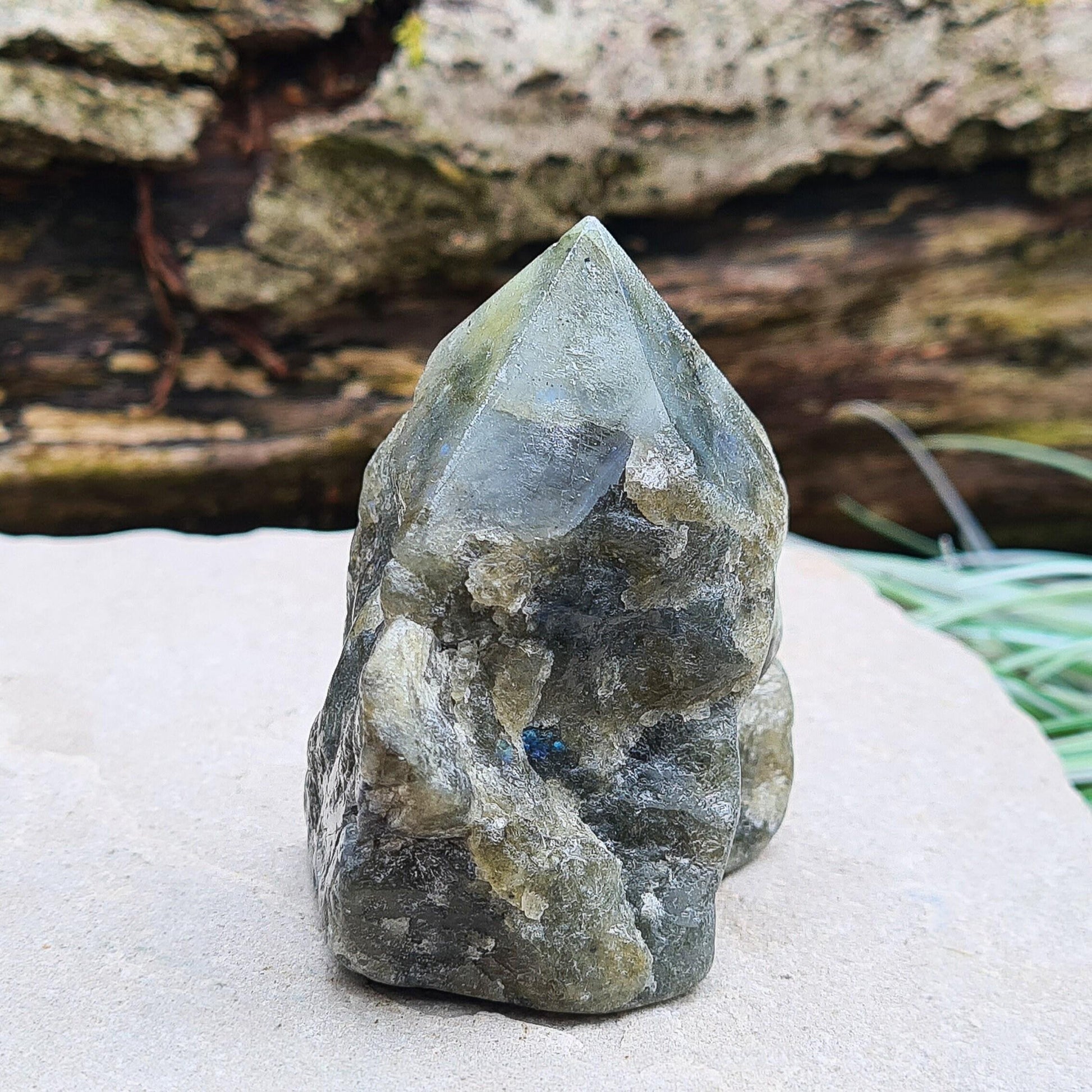 Labradorite Crystal, Standing Point, also known as Spectrolite. Tip has been polished, base has been polished and the natural sides feel like they have been smoothed out also. Piece has some blue flash which can be seen in the right light and at the right angle.