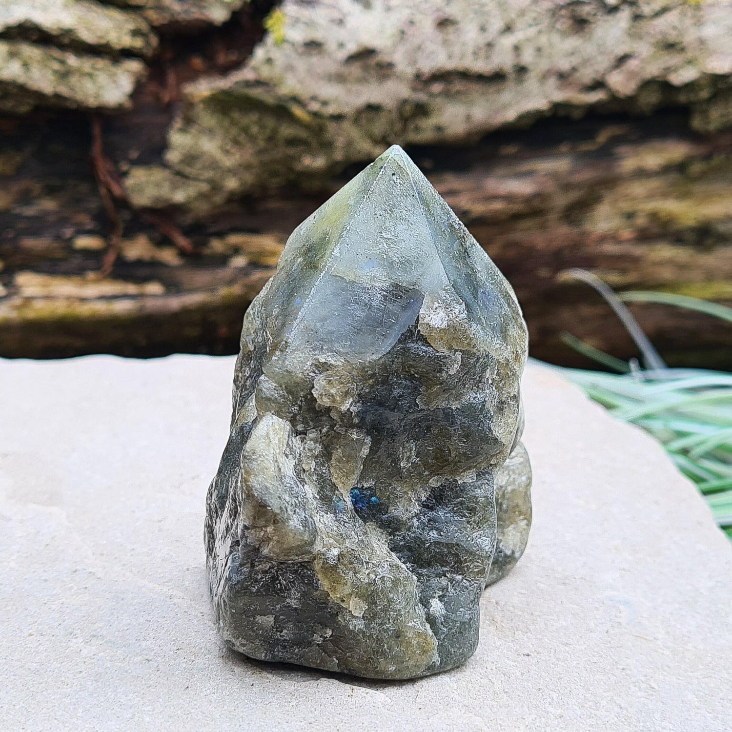 Labradorite Crystal, Standing Point, also known as Spectrolite. Tip has been polished, base has been polished and the natural sides feel like they have been smoothed out also. Piece has some blue flash which can be seen in the right light and at the right angle.