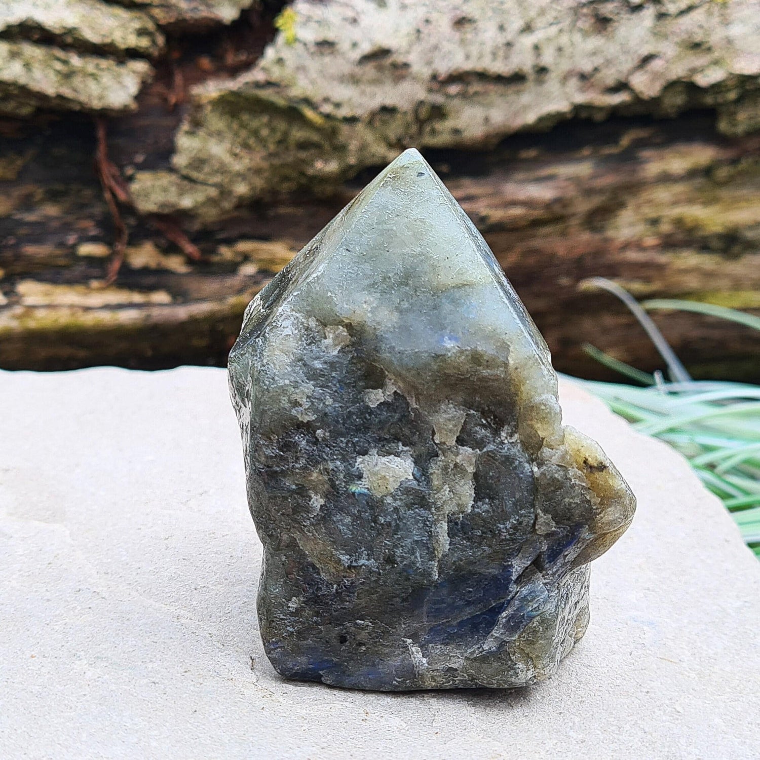 Labradorite Crystal, Standing Point, also known as Spectrolite. Tip has been polished, base has been polished and the natural sides feel like they have been smoothed out also. Piece has some blue flash which can be seen in the right light and at the right angle.