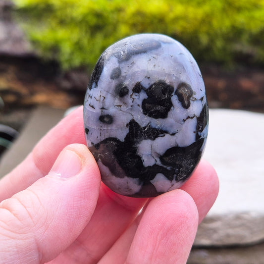 Indigo Gabbro Crystal Palm Stone, also known as Mystic Merlinite, originates from Madagascar. This a stunning stone formed deep within the Earth when molten magma cools slowly. 