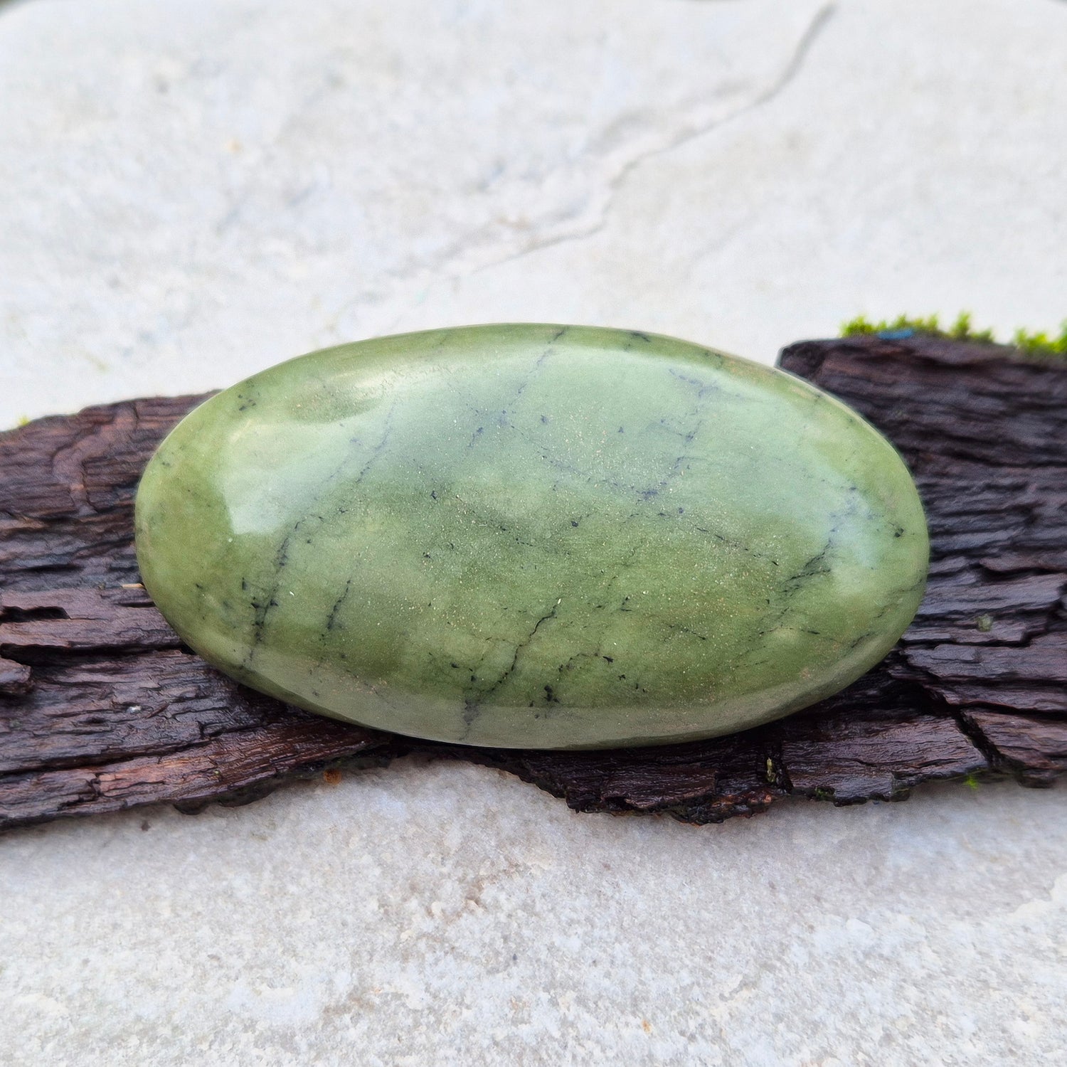 Nephrite Jade Crystal Palm Stone with black spots. From Pakistan. Lovely smooth polish, classic green Nephrite Jade colour.