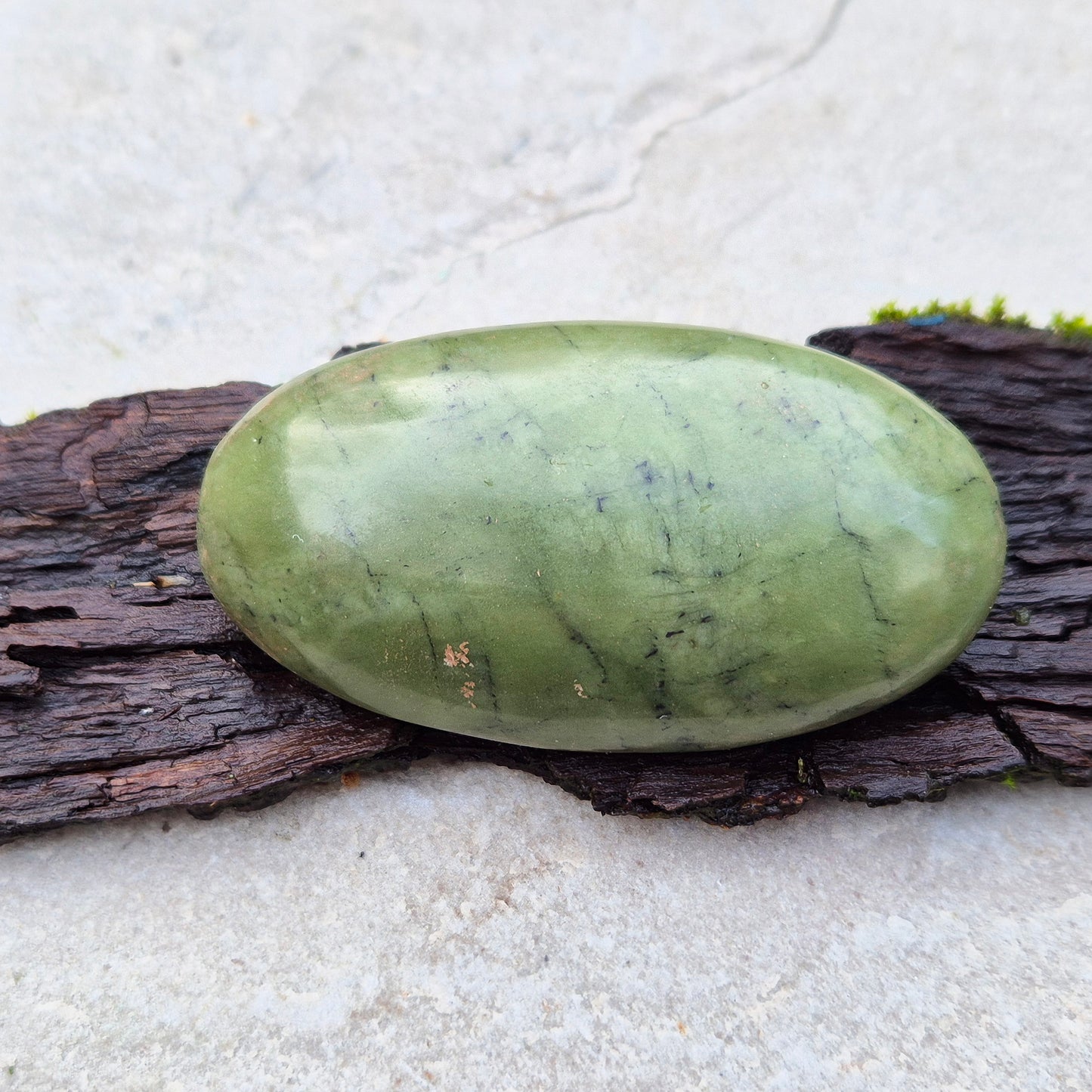 Nephrite Jade Crystal Palm Stone with black spots. From Pakistan. Lovely smooth polish, classic green Nephrite Jade colour.