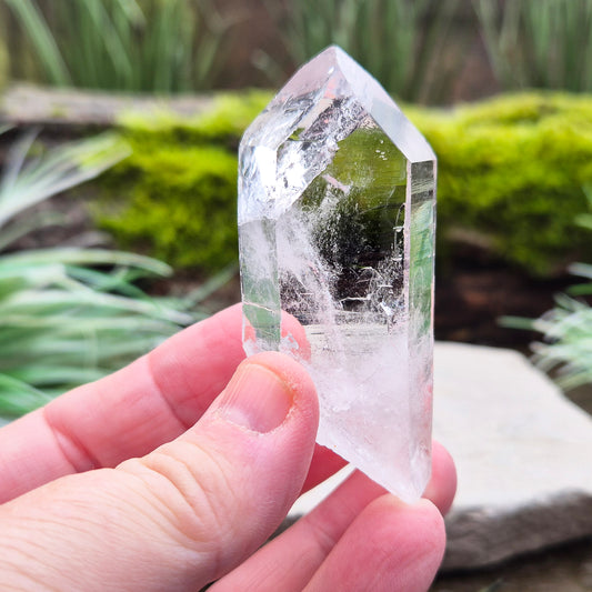 Quartz Crystal Point with a significant light reflecting incusion at the tip. From Brazil. This is a wonderfully natural quartz point with nice clarity.