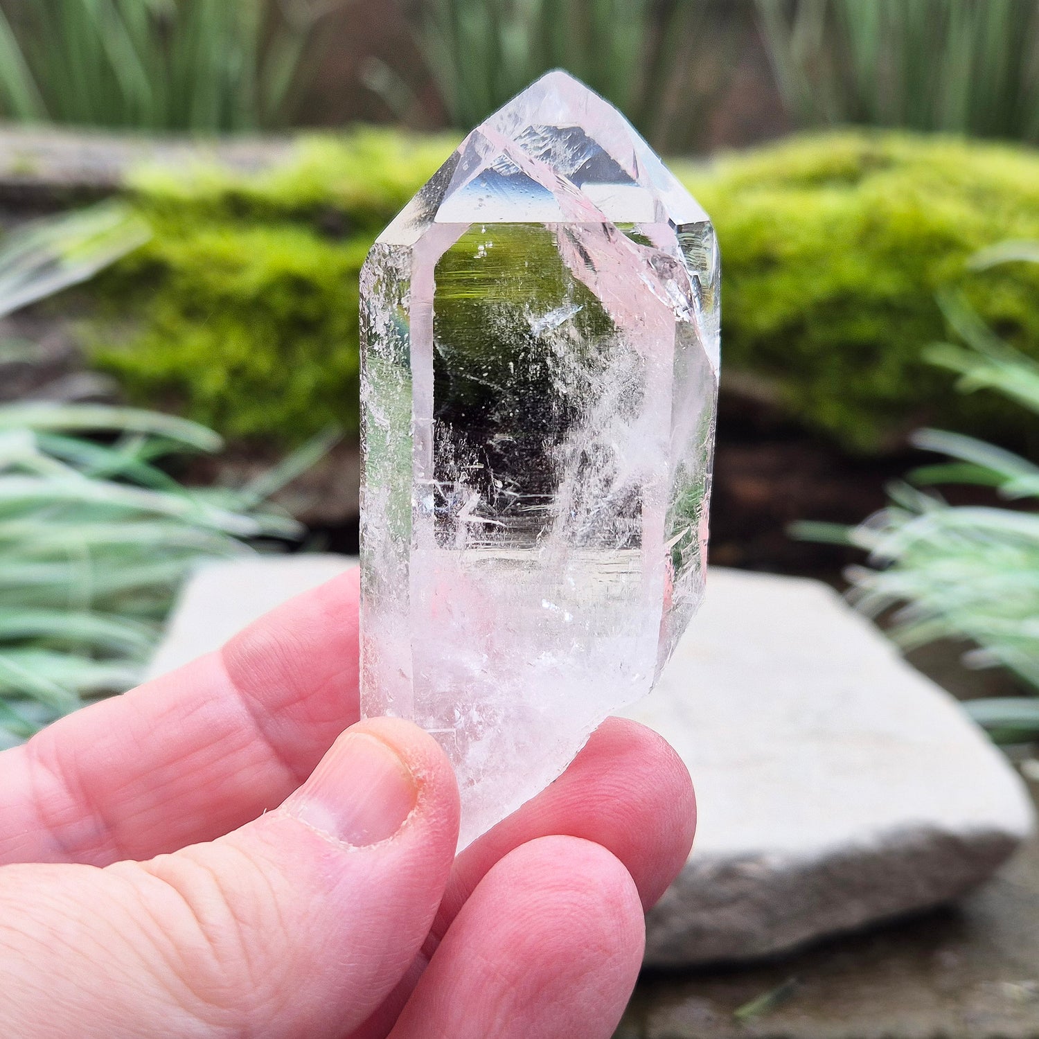 Quartz Crystal Point with a significant light reflecting incusion at the tip. From Brazil. This is a wonderfully natural quartz point with nice clarity.