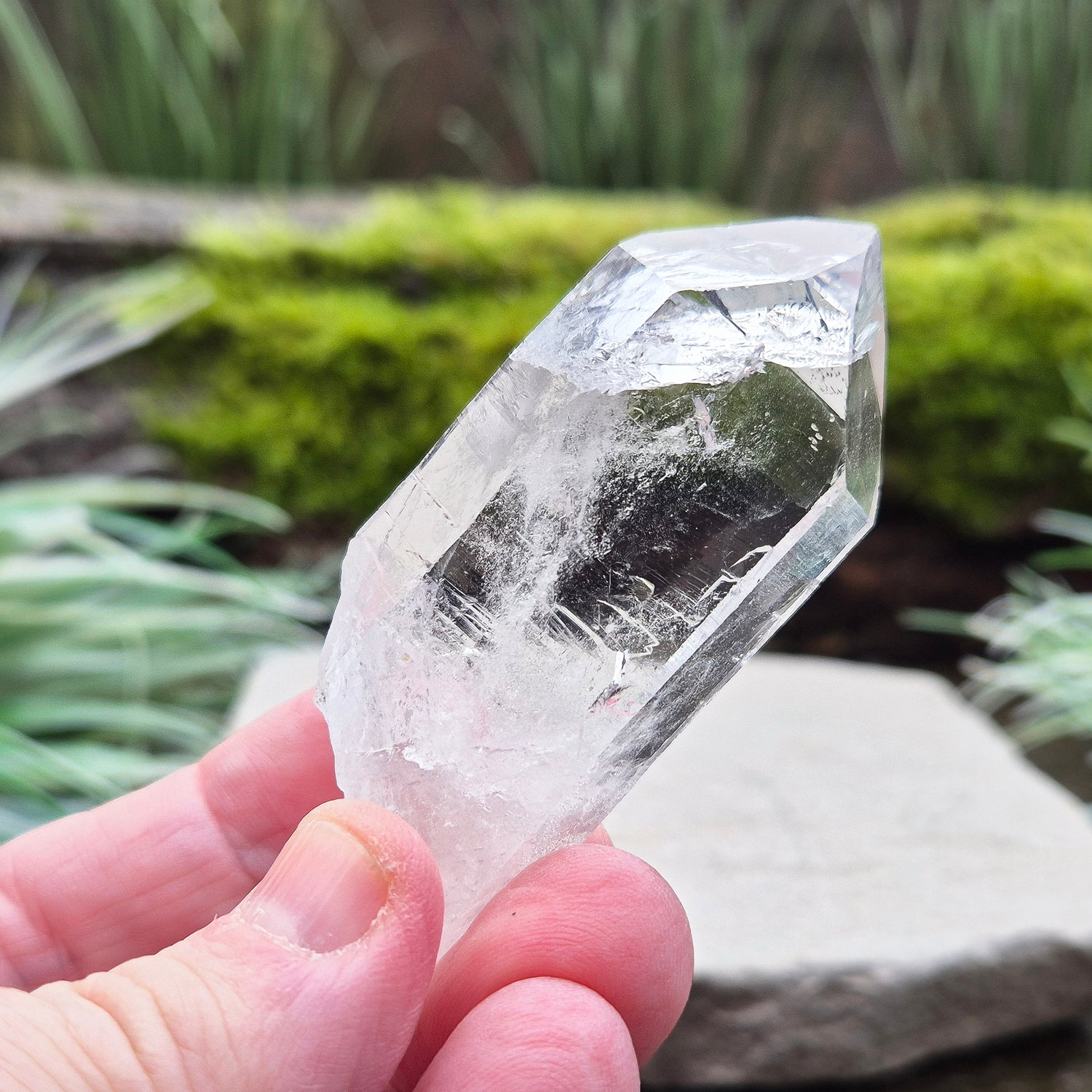 Quartz Crystal Point with a significant light reflecting incusion at the tip. From Brazil. This is a wonderfully natural quartz point with nice clarity.