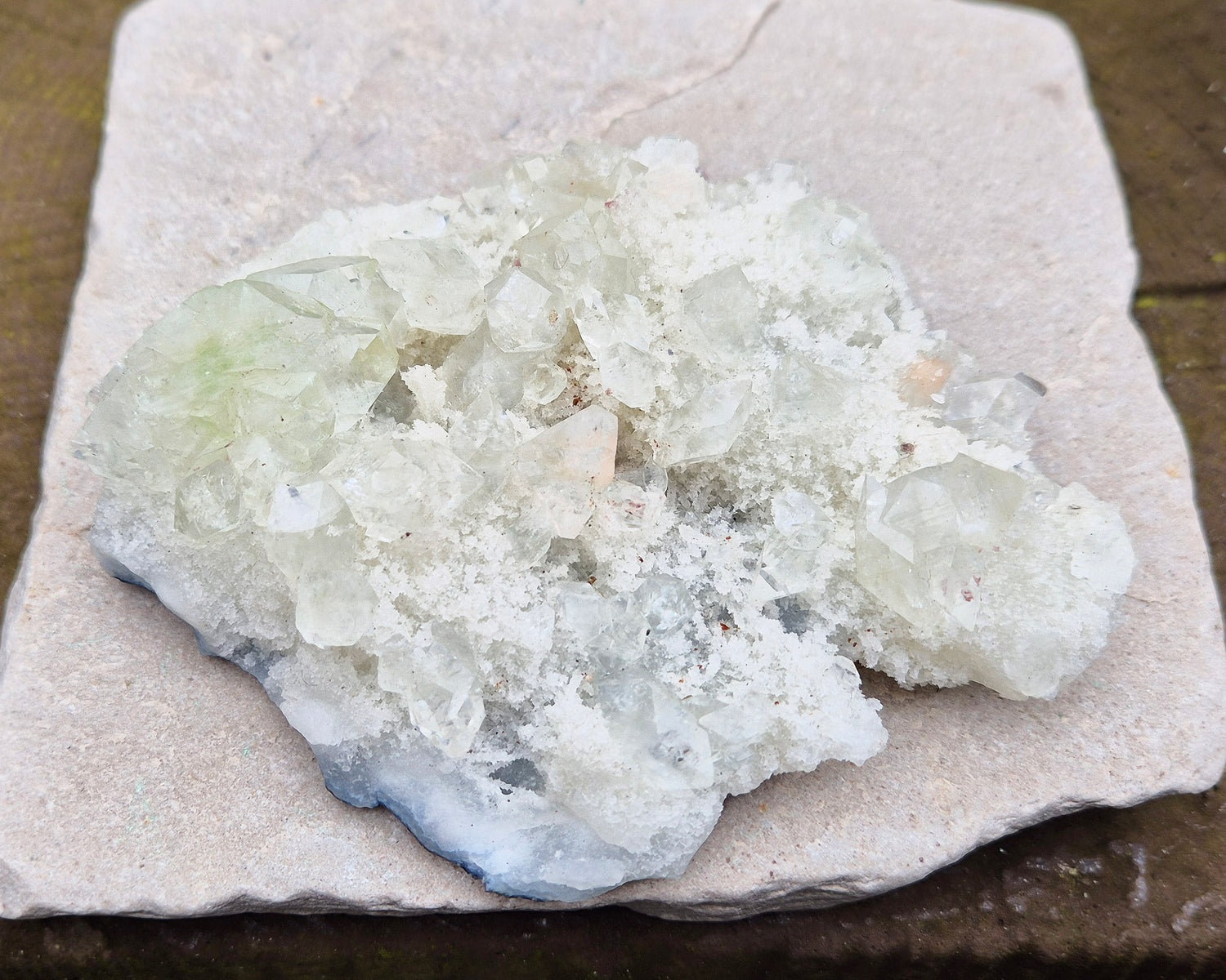 Apophyllite Crystal Cluster from India. Lovely cluster which has some double terminated apophyllite crystals on it, the largest of which has a hint of green within it.