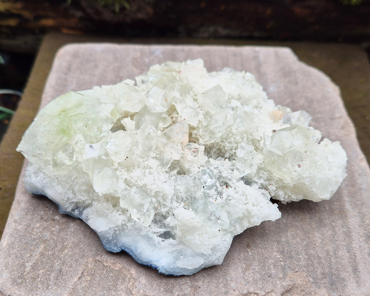 Apophyllite Crystal Cluster from India. Lovely cluster which has some double terminated apophyllite crystals on it, the largest of which has a hint of green within it.