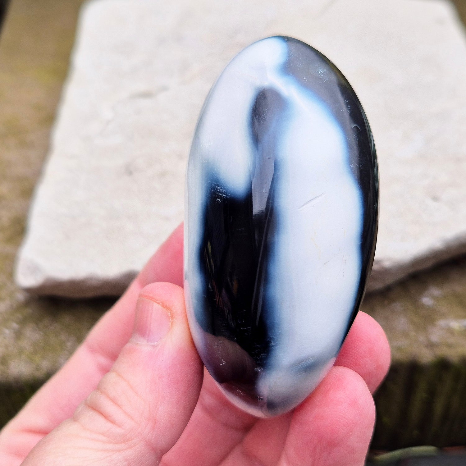 Orca Agate crystal pebble, originally from Madagascar, are also known as Grey Agate. This unique stone is named after the Orca whale due to its distinctive black and white markings.