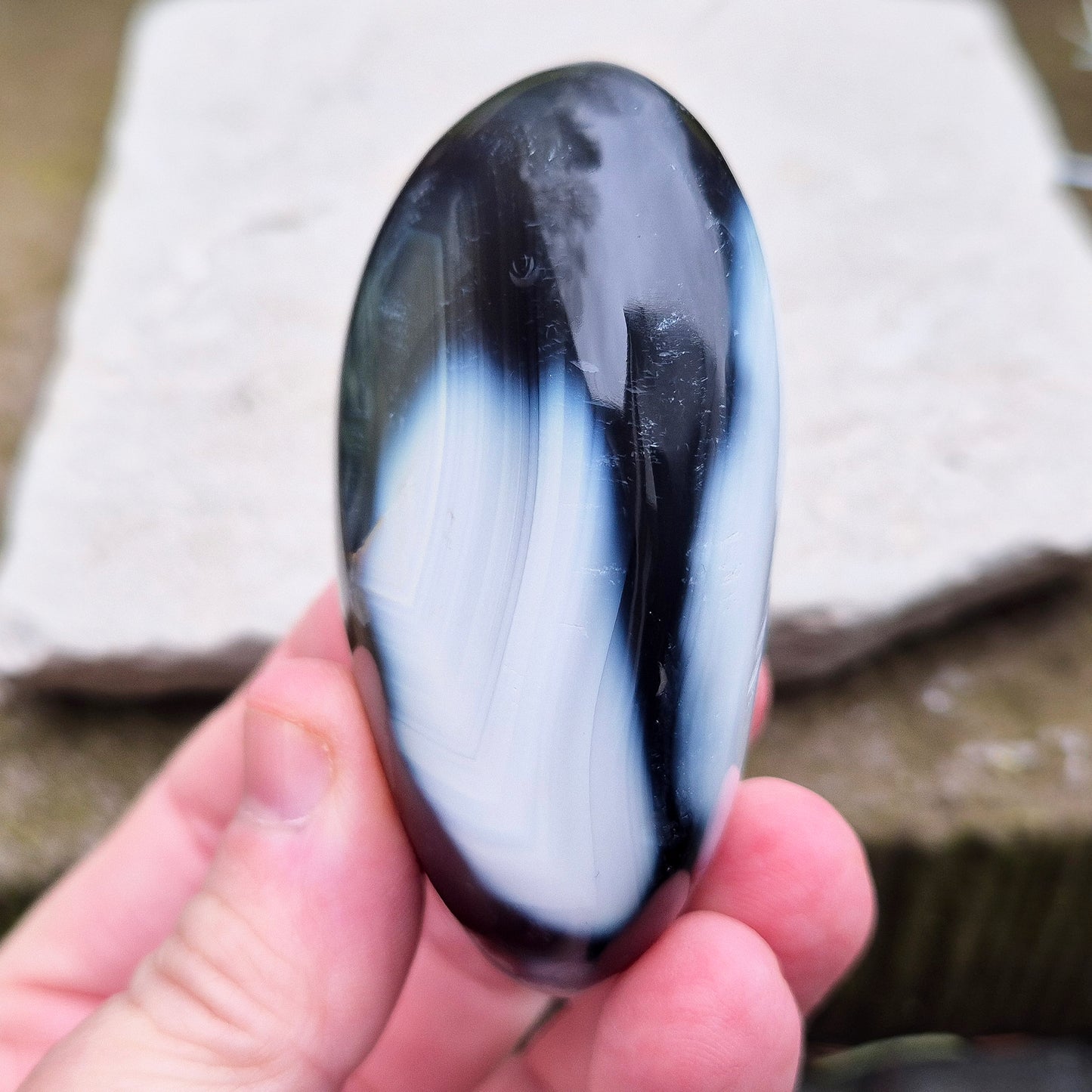 Orca Agate crystal pebble, originally from Madagascar, are also known as Grey Agate. This unique stone is named after the Orca whale due to its distinctive black and white markings.