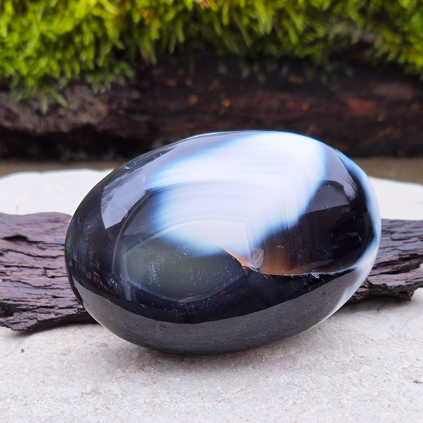 Orca Agate crystal pebble, originally from Madagascar, are also known as Grey Agate. This unique stone is named after the Orca whale due to its distinctive black and white markings.