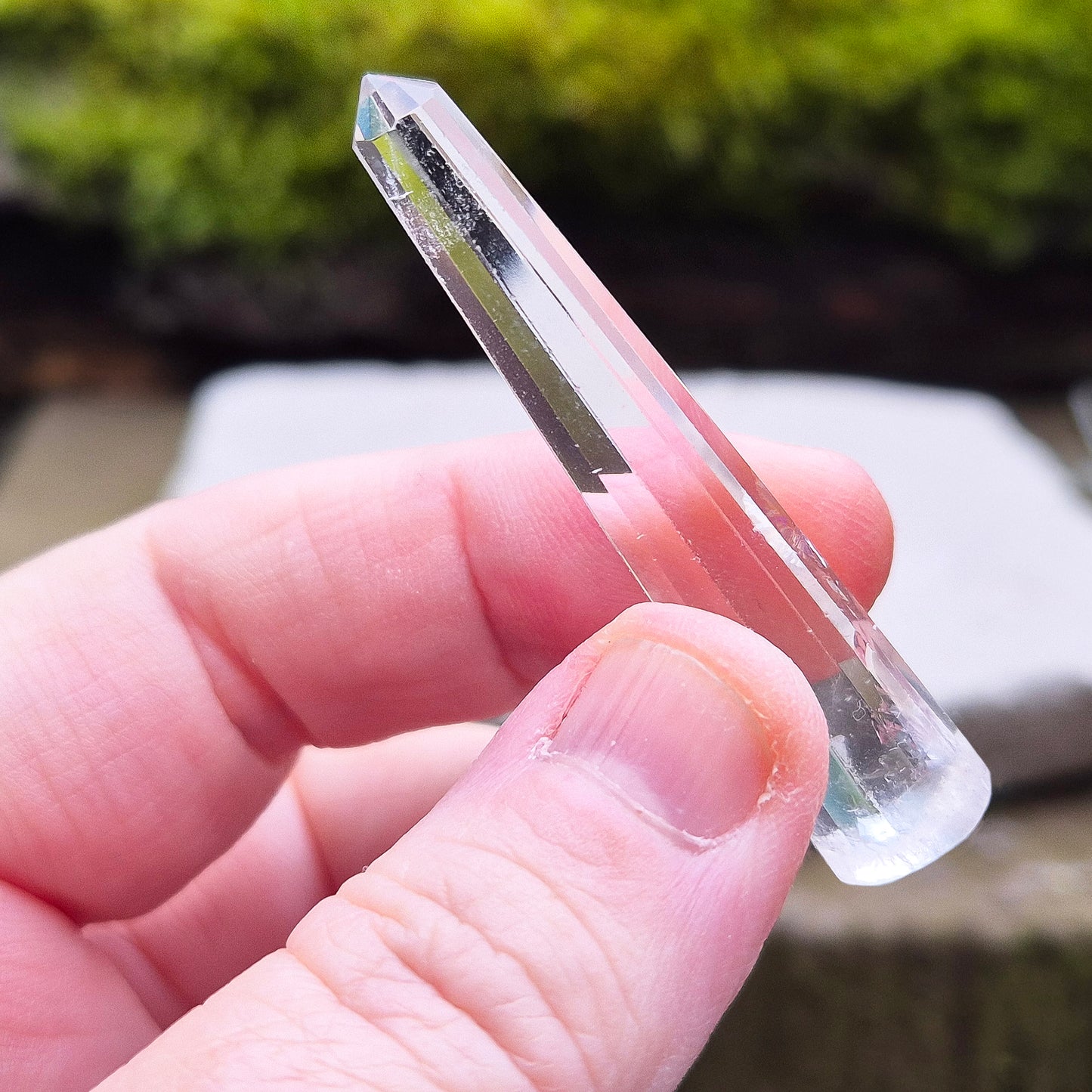 Mini Vogel Quartz Crystal Wand with 12 sides, pointed tip and rounded base, from Brazil. Has great clarity and a light reflecting inclusion at the base.