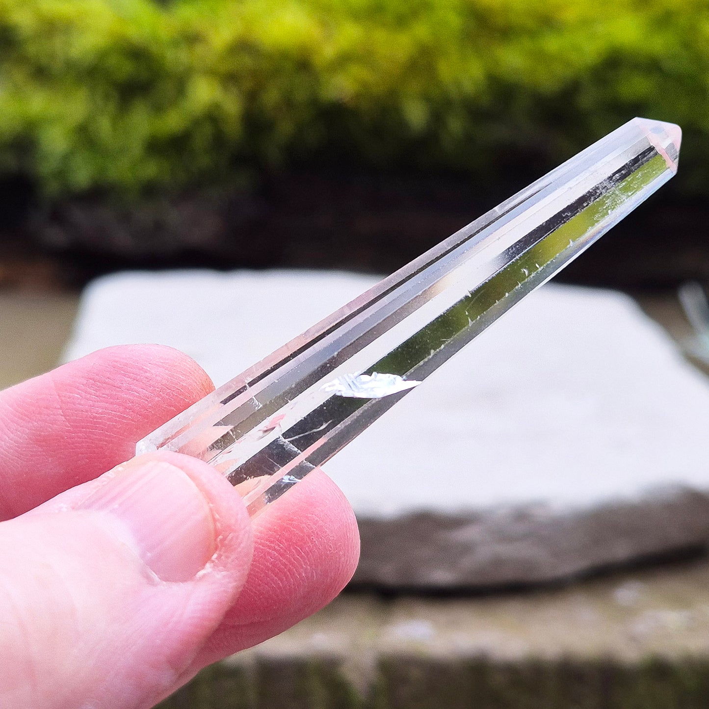 Mini Vogel Quartz Crystal Wand with 12 sides, pointed tip and rounded base, from Brazil. Has great clarity and a light reflecting inclusion at the base.