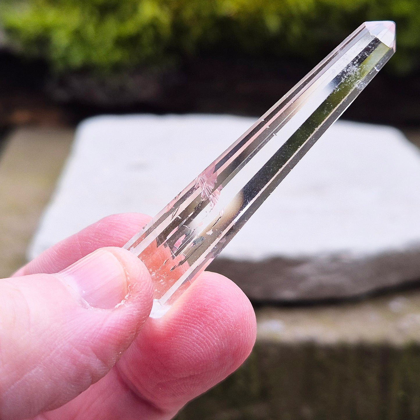 Mini Vogel Quartz Crystal Wand with 12 sides, pointed tip and rounded base, from Brazil. Has great clarity and a light reflecting inclusion at the base.