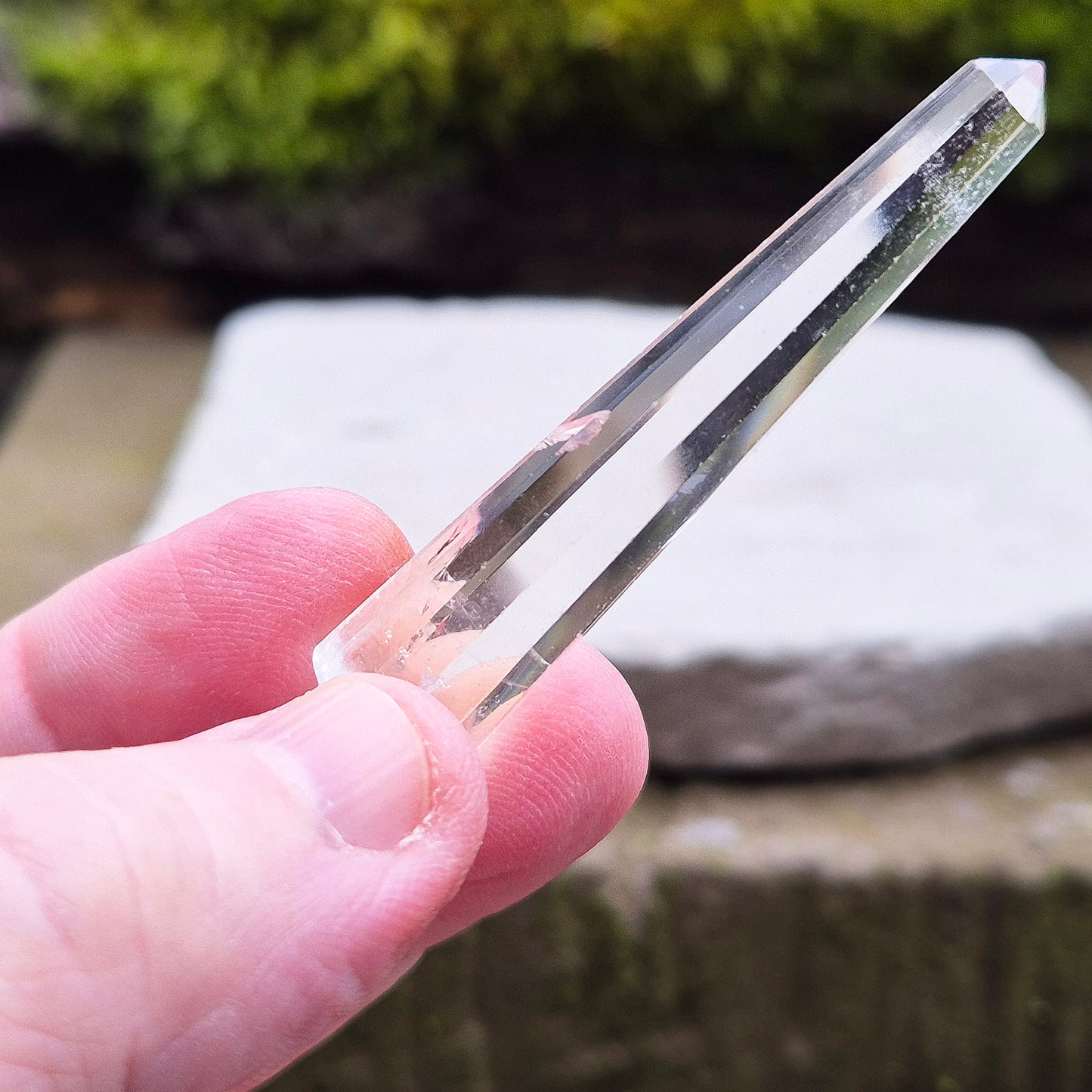 Mini Vogel Quartz Crystal Wand with 12 sides, pointed tip and rounded base, from Brazil. Has great clarity and a light reflecting inclusion at the base.