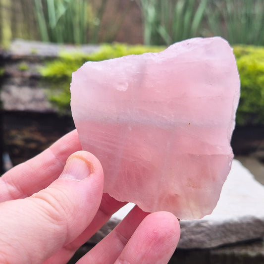 Rose Quartz Crystal Platform from South Africa. One side is left natural and the other side has been cut flat. Great for displaying other crystals and jewellry. 