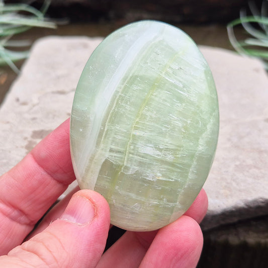 Pistachio Calcite Crystal Palm Stone. From the Khyber Pakhtunkhwa province of Pakistan. Pistachio Calcite is a pale green to pistachio colour variety of Green Calcite