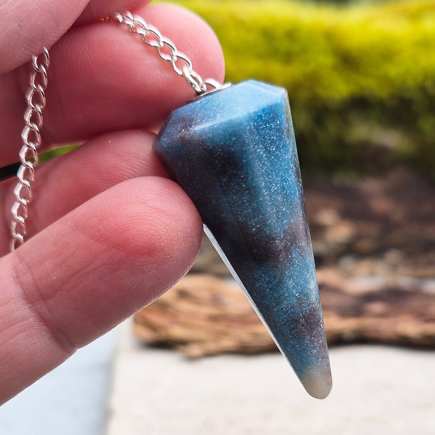 Trolleite Crystal Pendulum. From Brazil. Chain has a silver ring at the end of it. Comes in a box or pouch to keep it in.