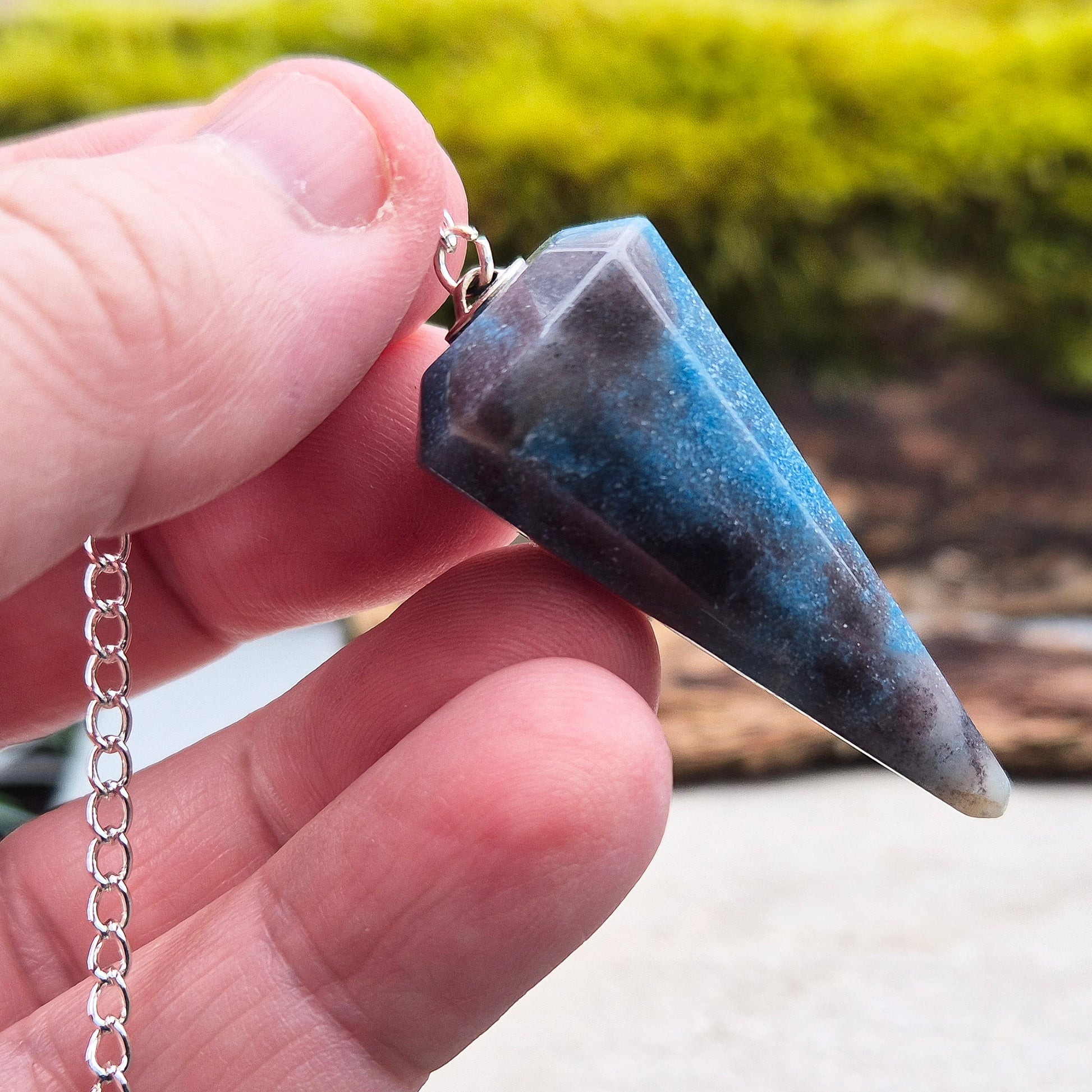Trolleite Crystal Pendulum. From Brazil. Chain has a silver ring at the end of it. Comes in a box or pouch to keep it in.