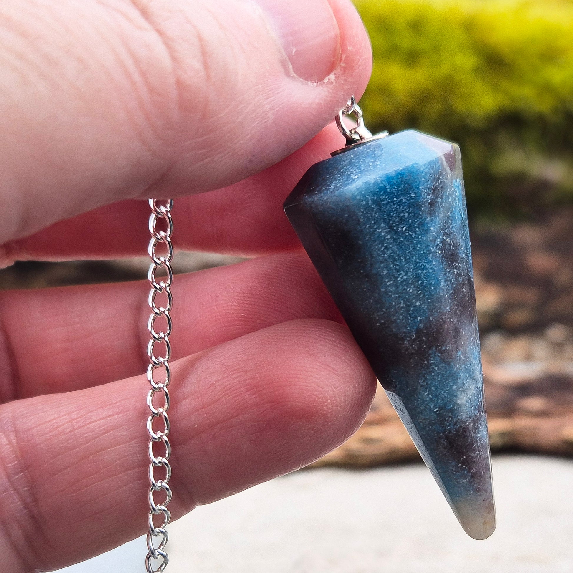 Trolleite Crystal Pendulum. From Brazil. Chain has a silver ring at the end of it. Comes in a box or pouch to keep it in.