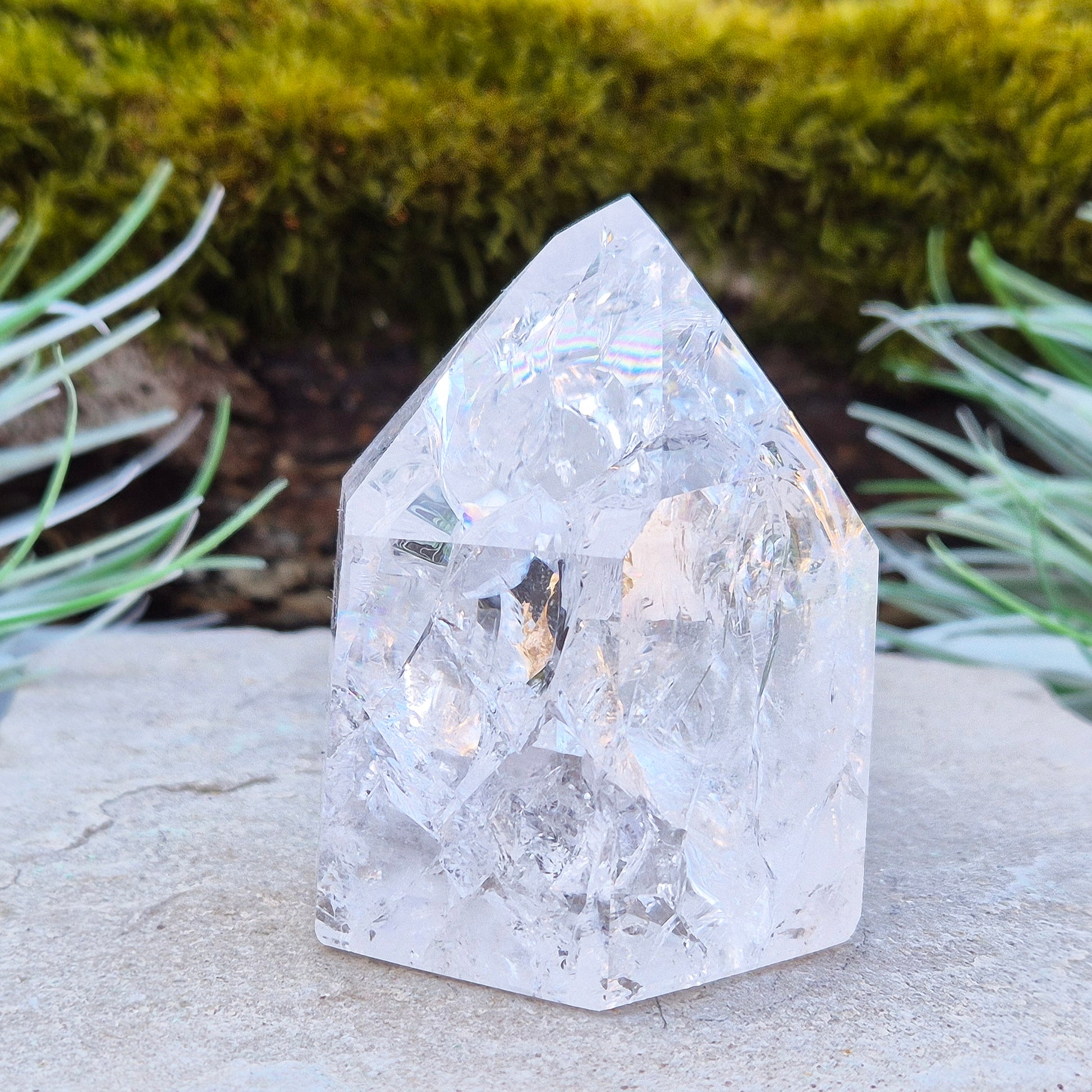Fire and Ice Quartz Polished Standing Point (also known as Rainbow Quartz) is created by heating and rapidly cooling quartz. This results in a crystal with a high vibration, reflective inclusions, and occasional rainbows, all contributing to the vibrant light within the crystal.