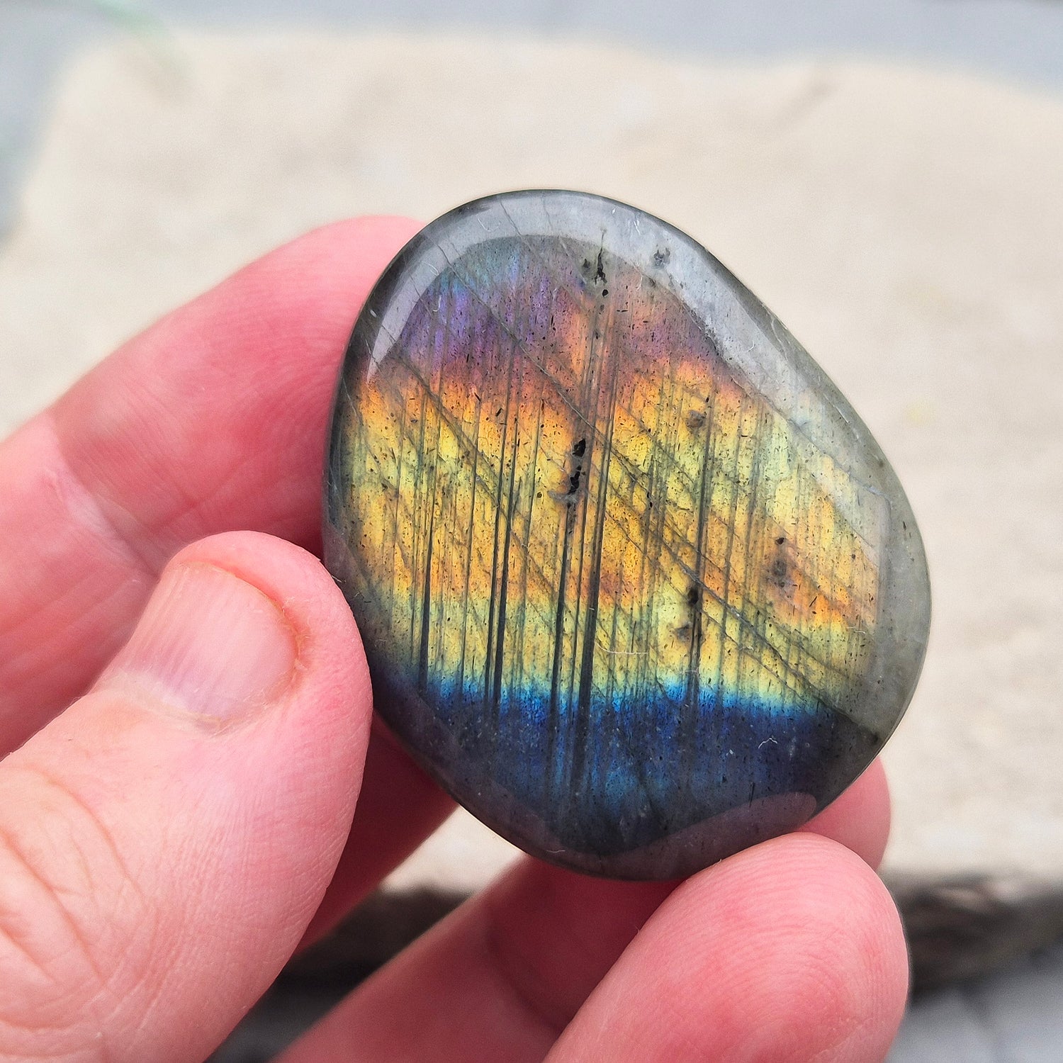 Labradorite Crystal Palm Stone, also known as Spectrolite. From Madagaascar. Has a lovely blue, yellow, gold, pinky purple flash when in the light at certain angles.