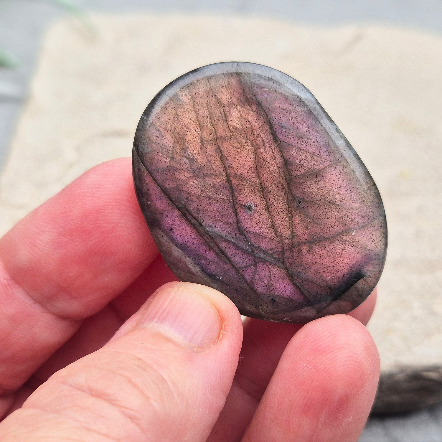 Labradorite Crystal Palm Stone, also known as Spectrolite. From Madagaascar. Has a lovely pink and purple flash when in the light at certain angles.