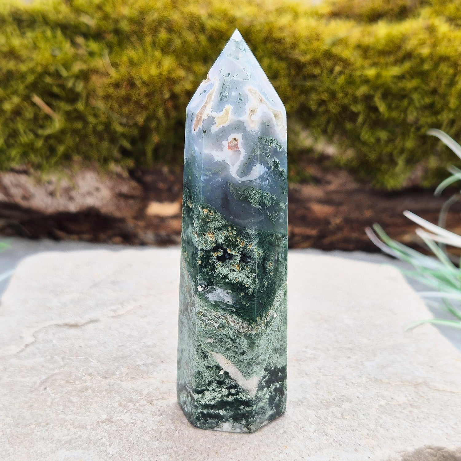 This exquisite Moss Agate Tower features a 6 sided Generator tip, polished surface with unique moss-like inclusions, creating a captivating natural design. 