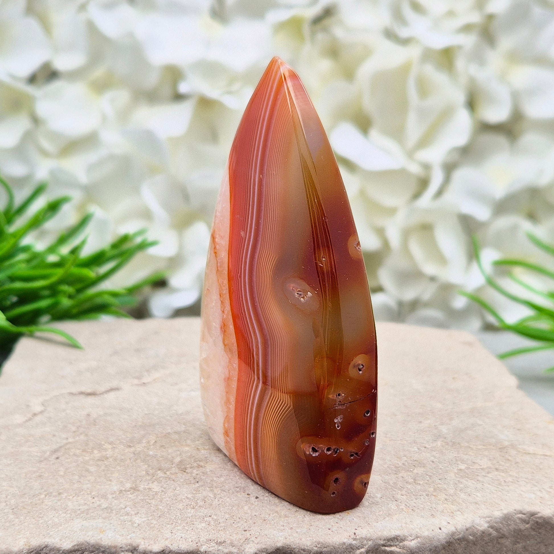 Red Banded Agate Flame with Quartz. This beautiful polished, flame-shaped crystal features bands of red and orange agate alongside quartz.