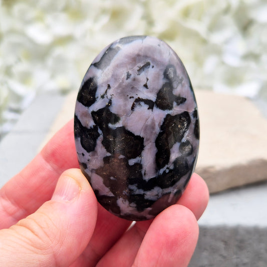 Indigo Gabbro Crystal Palm Stone (Mystic Merlinite) from Madagascar. This stunning Indigo Gabbro palm stone features a mix of dark black and deep purple colours with shiny grey and white flecks. It’s a heavy, solid stone, perfect for holding or carrying with you.