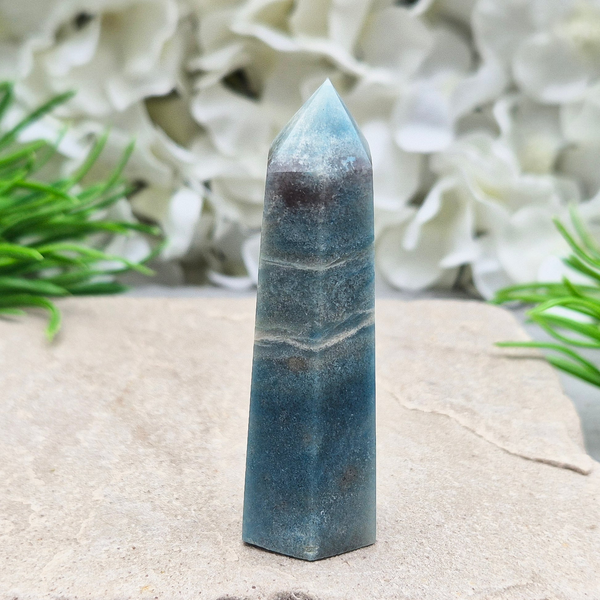 This beautiful Trolleite Point/Tower comes from Brazil, showcasing its calming bluish-gray hues. Perfectly balanced for energy work, this point is designed to direct and amplify energy upright and outward. Trolleite is cherished for its ability to promote focus, calm the mind, and deepen spiritual connection.