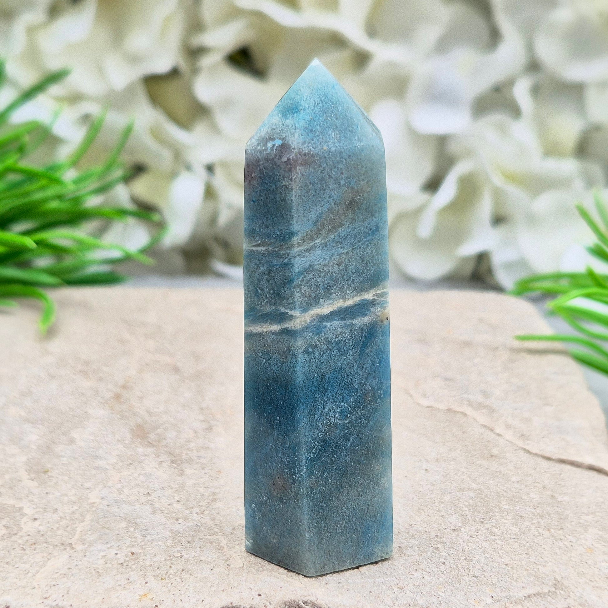 This beautiful Trolleite Point/Tower comes from Brazil, showcasing its calming bluish-gray hues. Perfectly balanced for energy work, this point is designed to direct and amplify energy upright and outward. Trolleite is cherished for its ability to promote focus, calm the mind, and deepen spiritual connection.