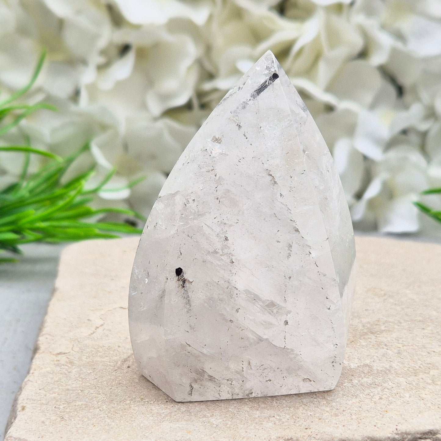 Tourmalinated Quartz Crystal Flame from Brazil radiates both clarity and grounded strength. This striking piece combines the amplifying energy of clear Quartz with the protective, stabilising force of Black Tourmaline. Formed into a polished flame shape