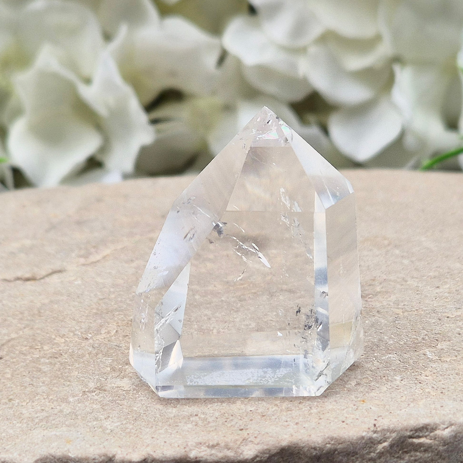 Clear Quartz Polished Point – From Brazil. This beautiful Quartz point is polished to enhance its natural clarity, and there looks to be a small phantom at the base of it.