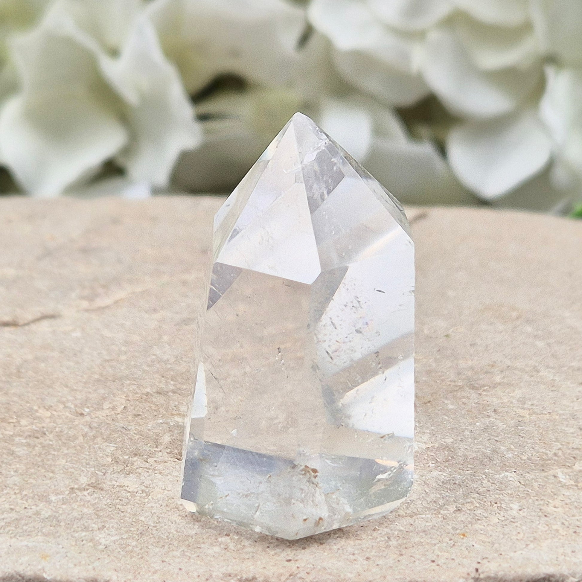 Clear Quartz Polished Point – From Brazil. This beautiful Quartz point is polished to enhance its natural clarity, and there looks to be a small phantom at the base of it.