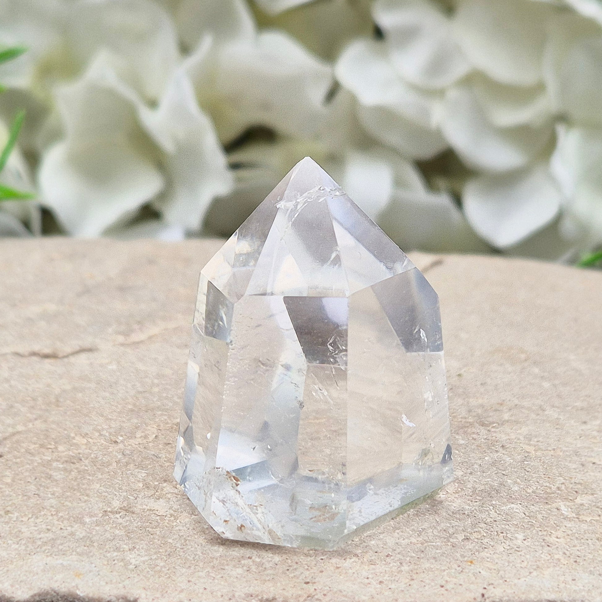 Clear Quartz Polished Point – From Brazil. This beautiful Quartz point is polished to enhance its natural clarity, and there looks to be a small phantom at the base of it.