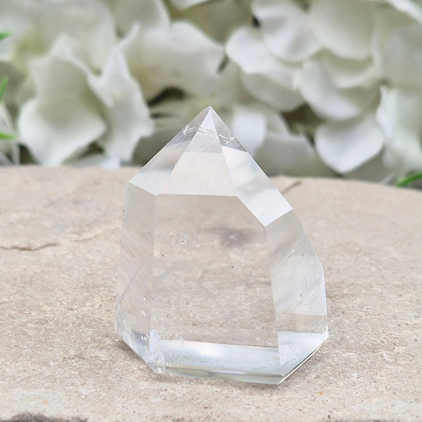 Clear Quartz Polished Point – From Brazil. This beautiful Quartz point is polished to enhance its natural clarity, and there looks to be a small phantom at the base of it.