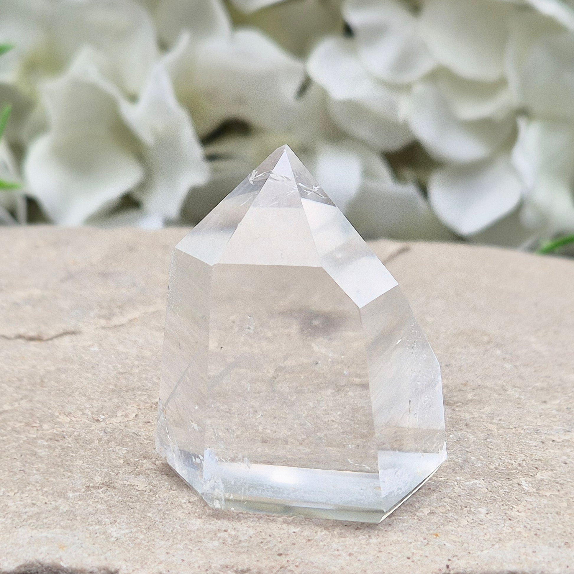 Clear Quartz Polished Point – From Brazil. This beautiful Quartz point is polished to enhance its natural clarity, and there looks to be a small phantom at the base of it.