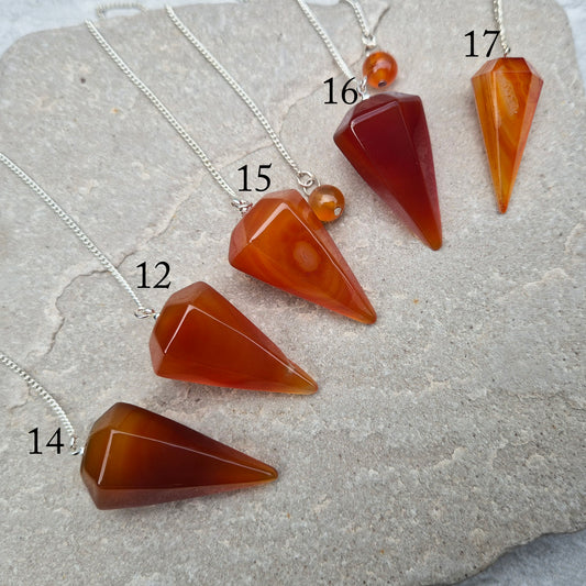 Carnelian Crystal Pendulum. This Carnelian crystal pendulum features a carnelian crystal and a orange bead at the end of the chain. 