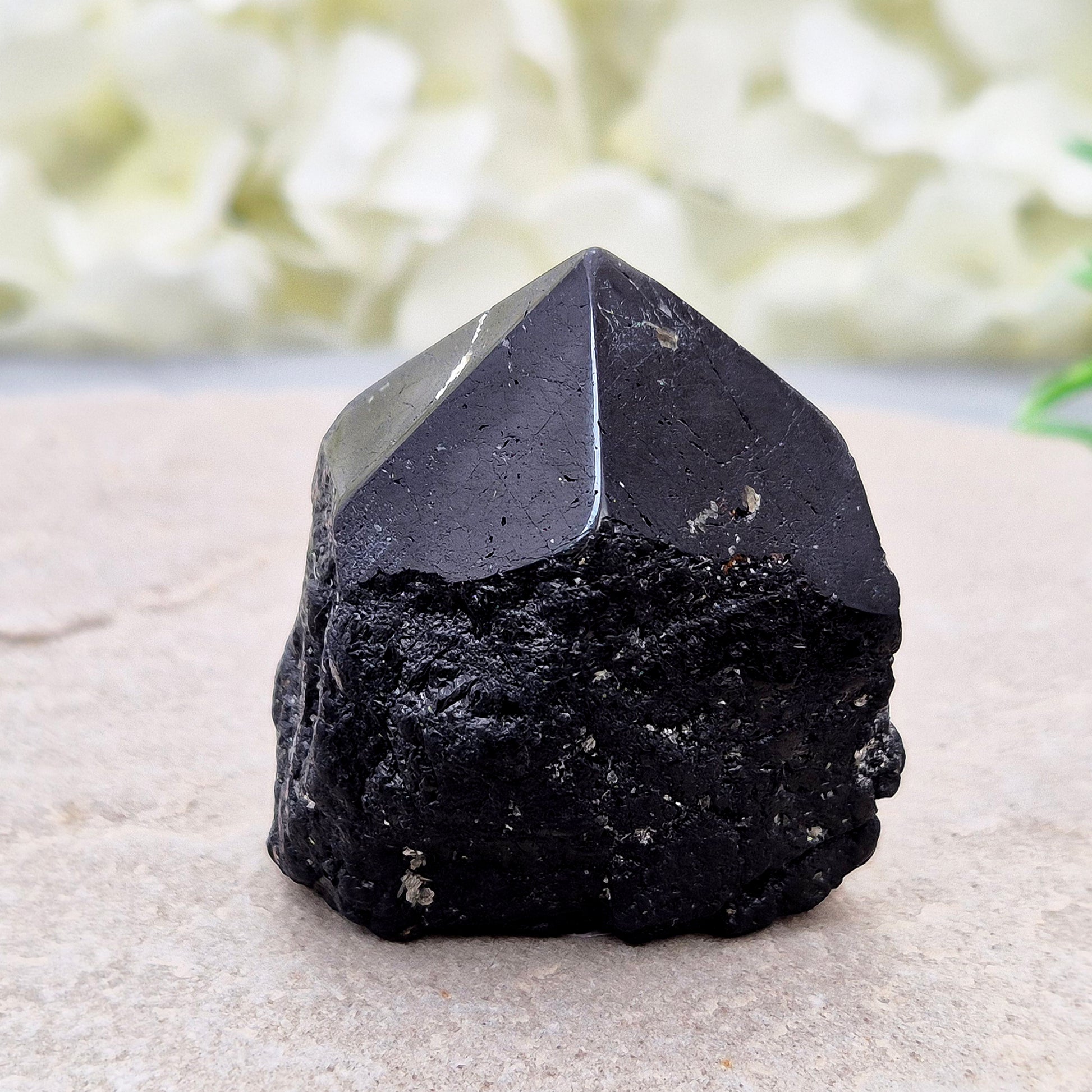 Black Tourmaline point from Brazil, which has polished tip, natural sides and cut flatbase. Contains a few sparkly Mica inclusions. A perfect piece for anyone needing strong protection, energetic clarity, and emotional strength.