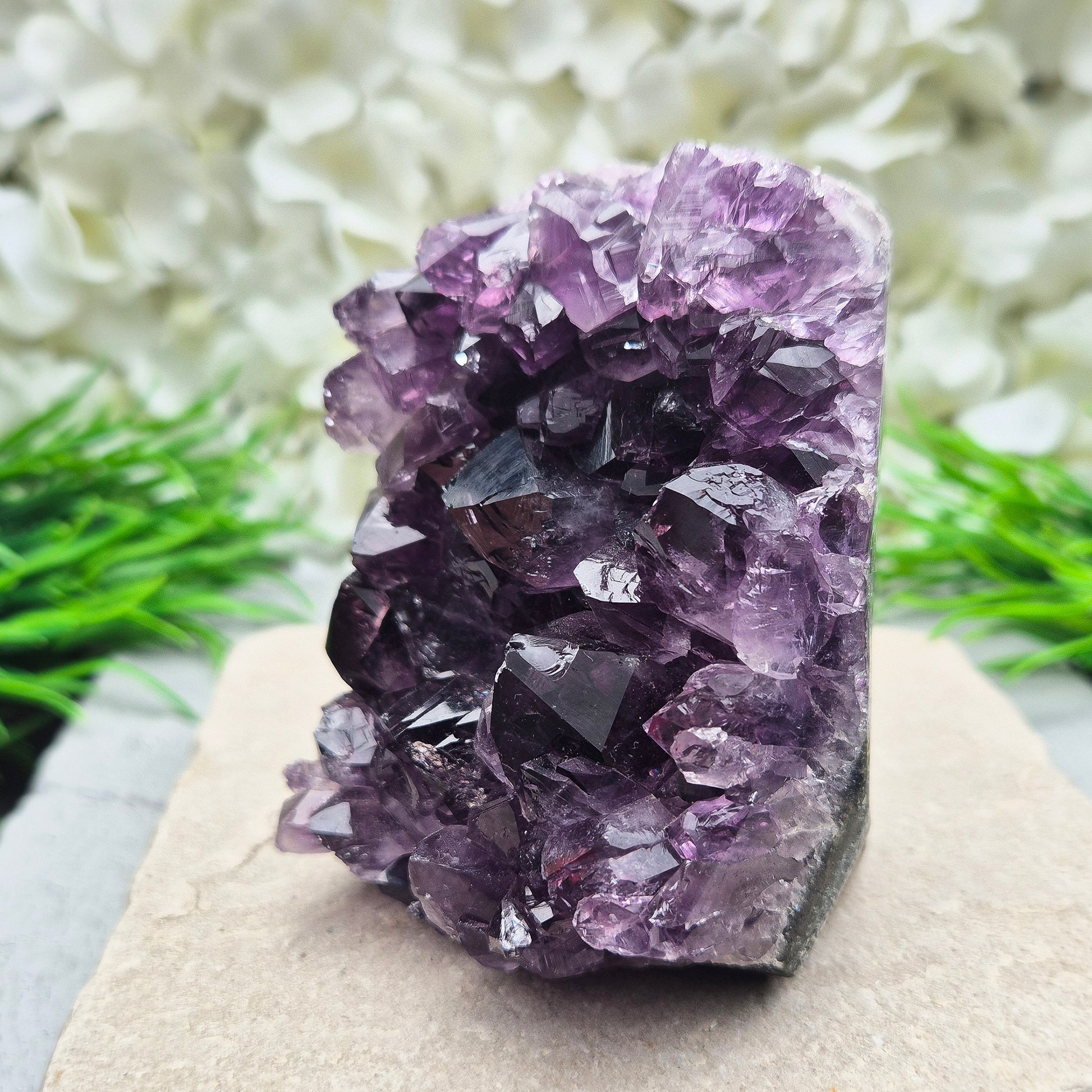 This beautiful self-standing Amethyst Geode from Brazil features lovely deep purple points and a natural open-face formation. Its deep colour and solid structure bring both visual beauty and a quiet strength to any space.