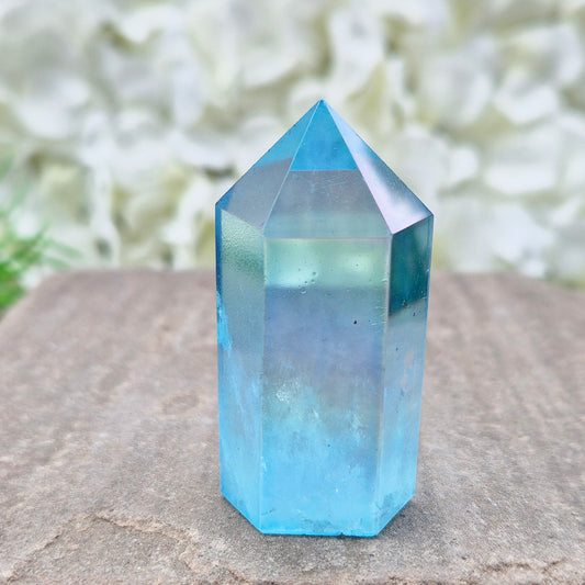 This beautiful Aqua Aura Quartz Standing Point from Brazil has an electric blue sheen with soft rainbow flashes, created by bonding pure gold to Quartz in a special heat process. The result is a striking crystal with a bright, peaceful energy. 