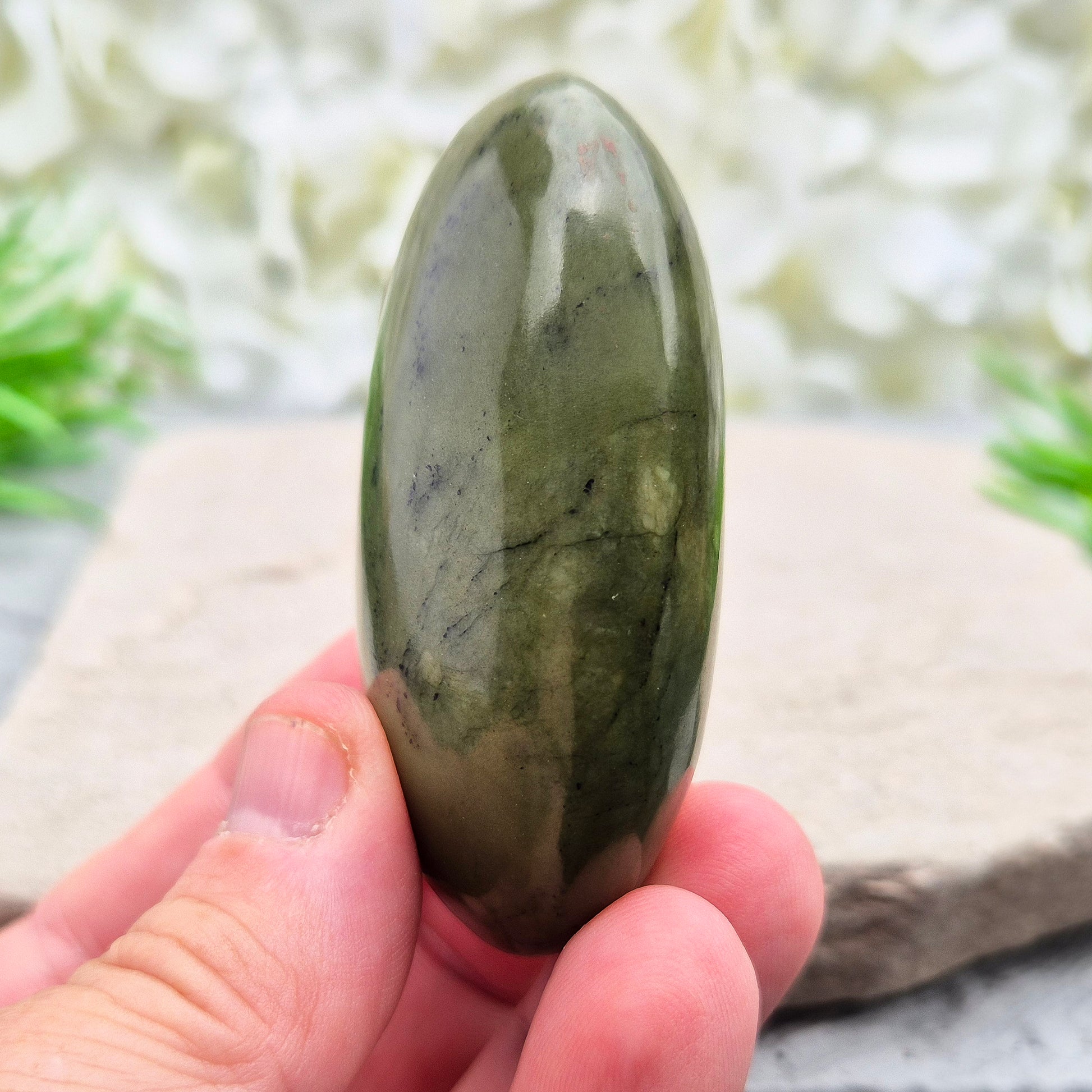 This smooth, polished Nephrite Jade palm stone from Pakistan features classic deep green tones. Nephrite Jade has long been seen as a stone of luck and wellbeing — but it's also a true ally for emotional balance and inner strength. 