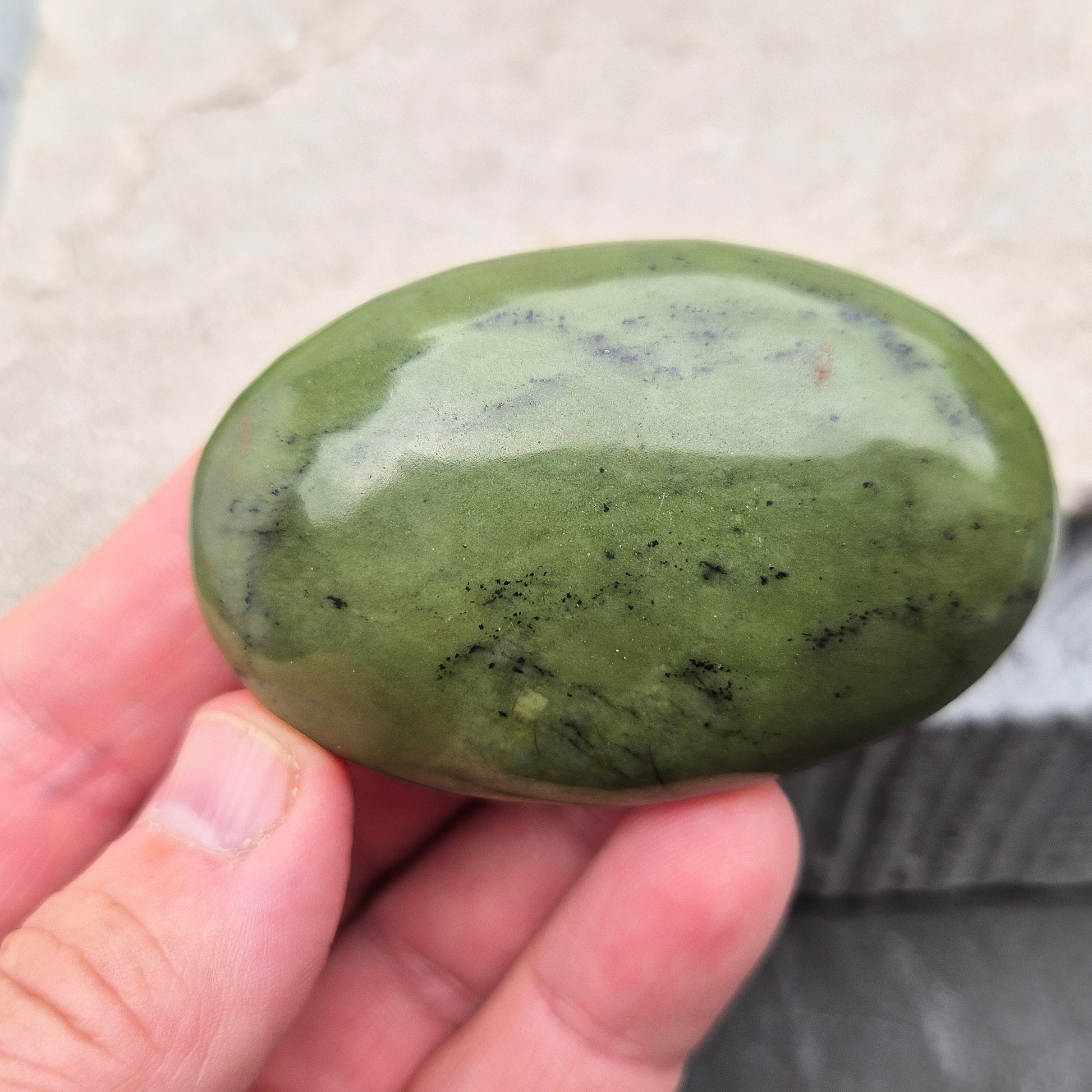 This smooth, polished Nephrite Jade palm stone from Pakistan features classic deep green tones. Nephrite Jade has long been seen as a stone of luck and wellbeing — but it's also a true ally for emotional balance and inner strength. 