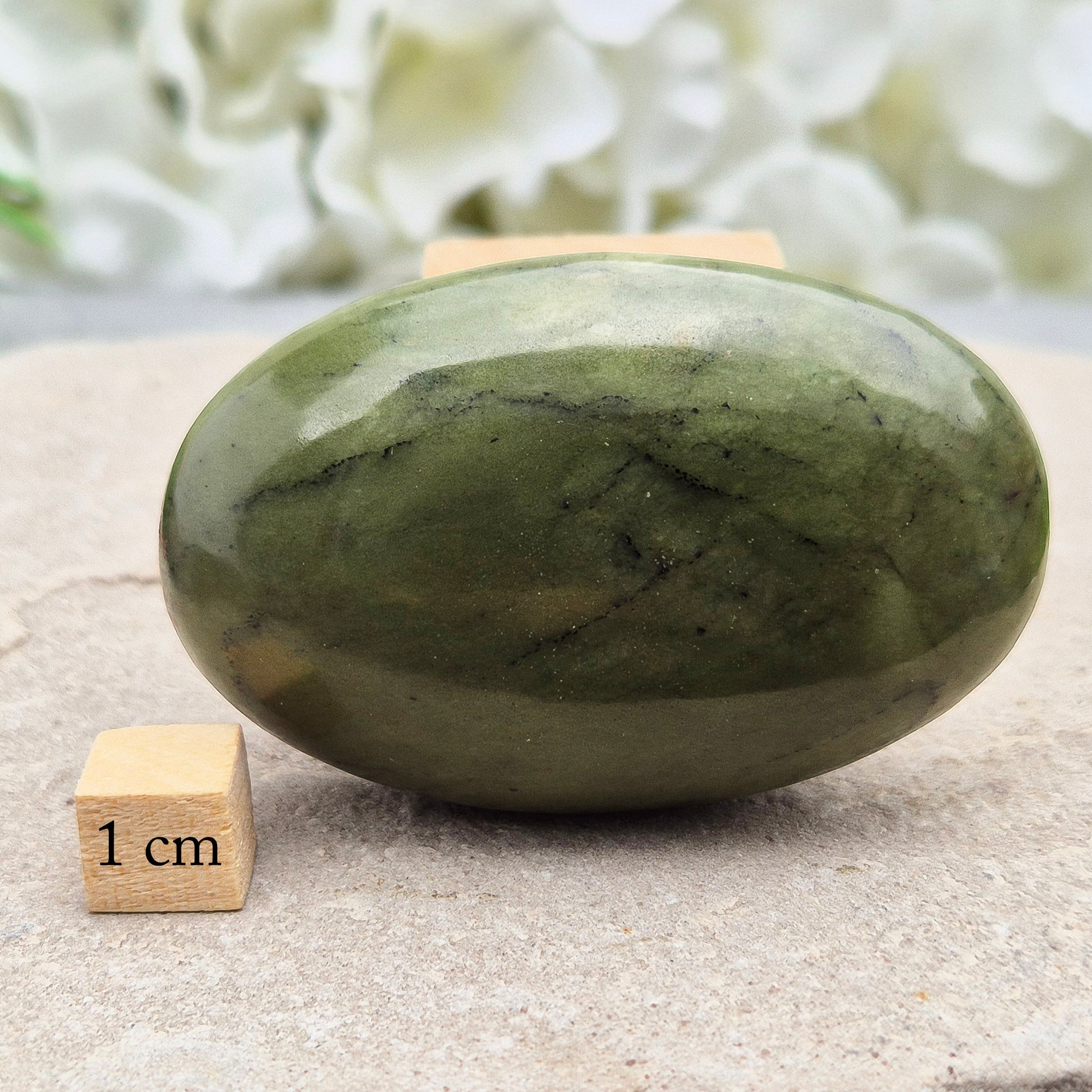 This smooth, polished Nephrite Jade palm stone from Pakistan features classic deep green tones. Nephrite Jade has long been seen as a stone of luck and wellbeing — but it's also a true ally for emotional balance and inner strength. 