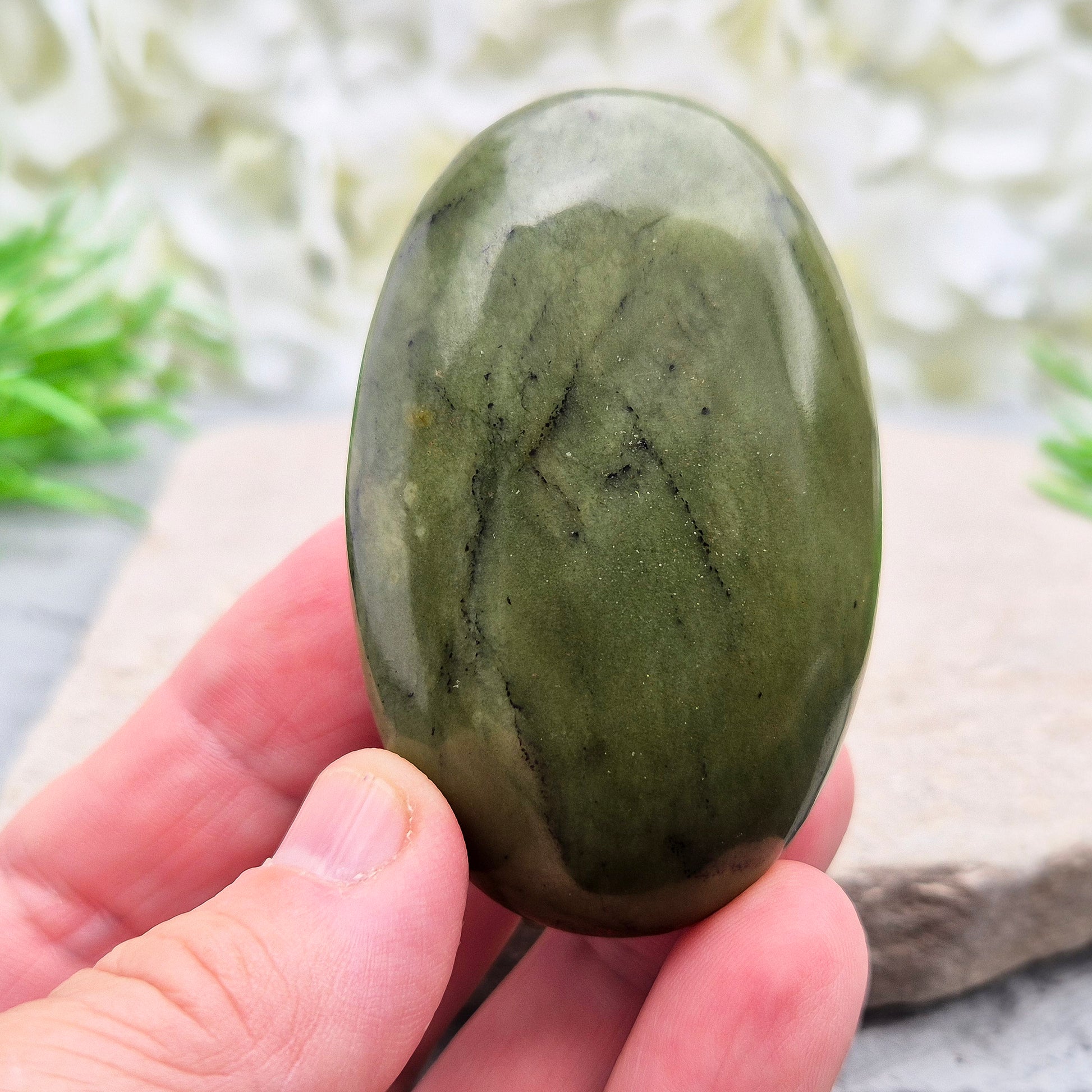 This smooth, polished Nephrite Jade palm stone from Pakistan features classic deep green tones. Nephrite Jade has long been seen as a stone of luck and wellbeing — but it's also a true ally for emotional balance and inner strength. 