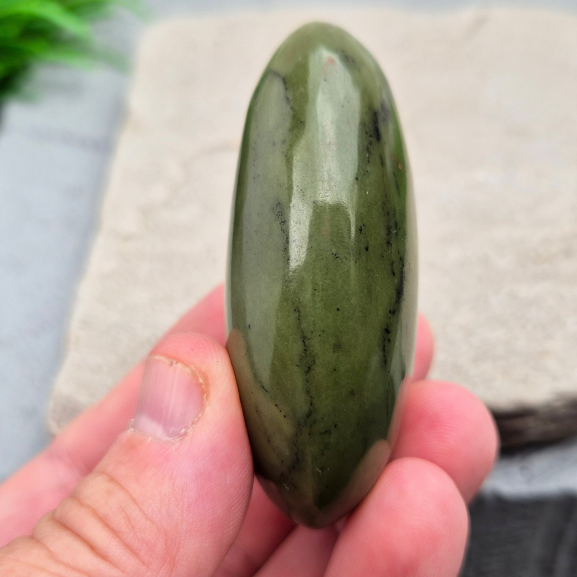 This smooth, polished Nephrite Jade palm stone from Pakistan features classic deep green tones. Nephrite Jade has long been seen as a stone of luck and wellbeing — but it's also a true ally for emotional balance and inner strength. 